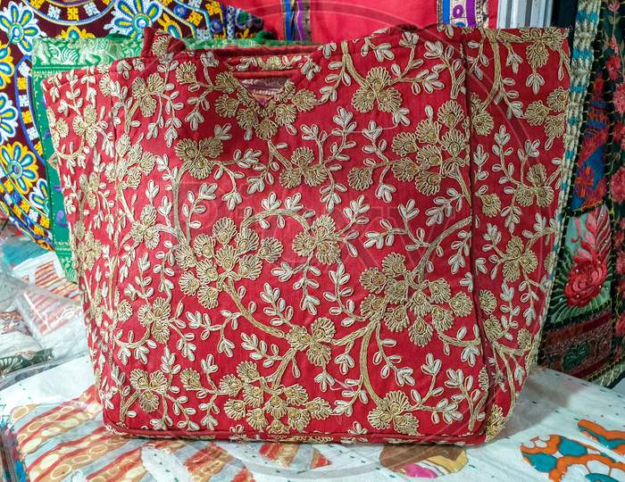 Mandi, Himachal Pradesh / India - 03 07 2020: Photo of colorful Indian artwork handbags kept in store for sale
