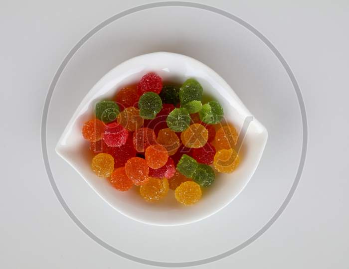 Sweet Mixed Color Jelly Candy In A White Bowl Against White Background
