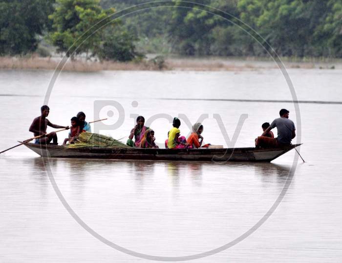 Villagers use a boat to reach a safer place in the flood-affected areas pf Puthimari village in Darrang, Assam on July 21, 2020