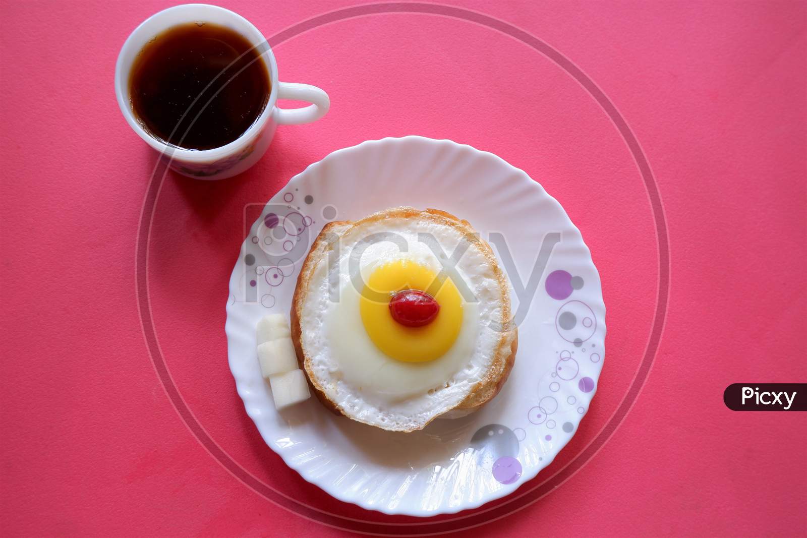 Homemade Fried Egg on burger and cup of Coffee for Breakfast,cherry  top view,