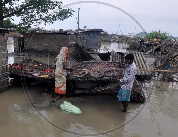 Villagers try to rebuild their damaged huts during the flood in Darrang, Assam on July 21, 2020