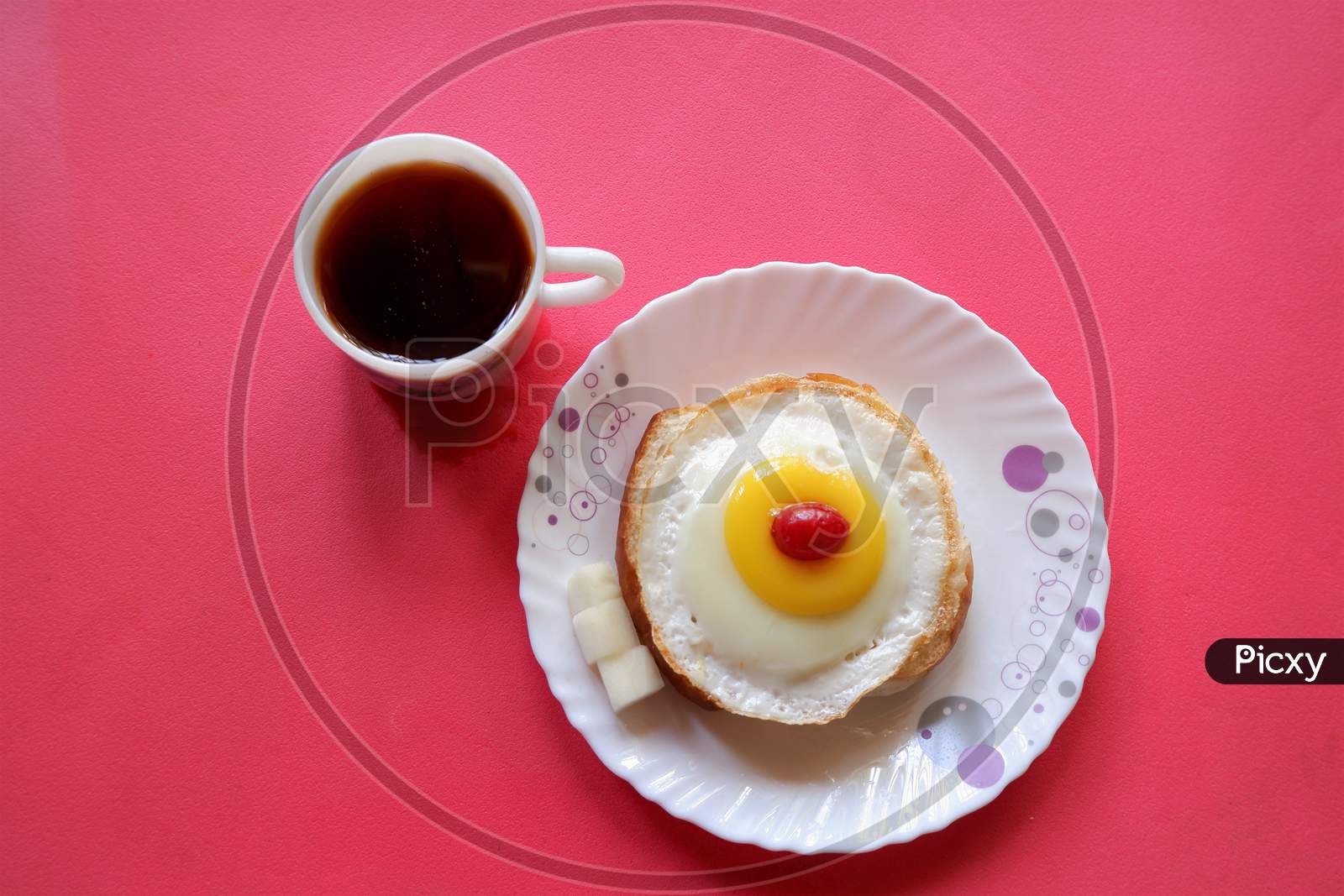 Homemade Fried Egg on burger and cup of Coffee for Breakfast,cherry  top view,
