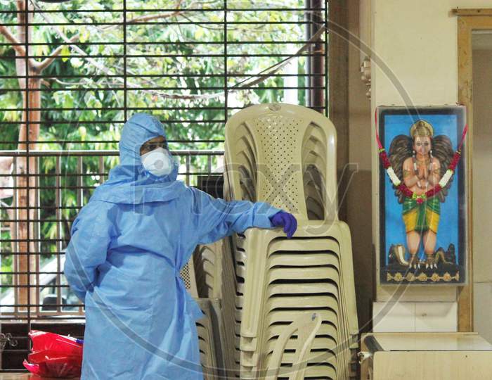 A Healthcare worker wearing a Personal Protective Equipment (PPE) waits to screen people at a camp set up for the coronavirus disease (COVID-19),inside a temple in  Mumbai, India on July 15, 2020.