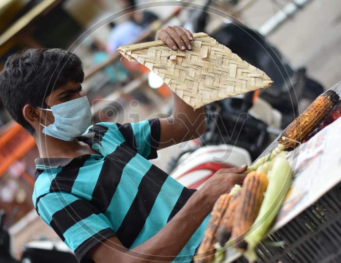 Hyderabad, Telangana, India. July-20-2020: Roasted Corn, People Are Doing Their Work Wearing Face Mask