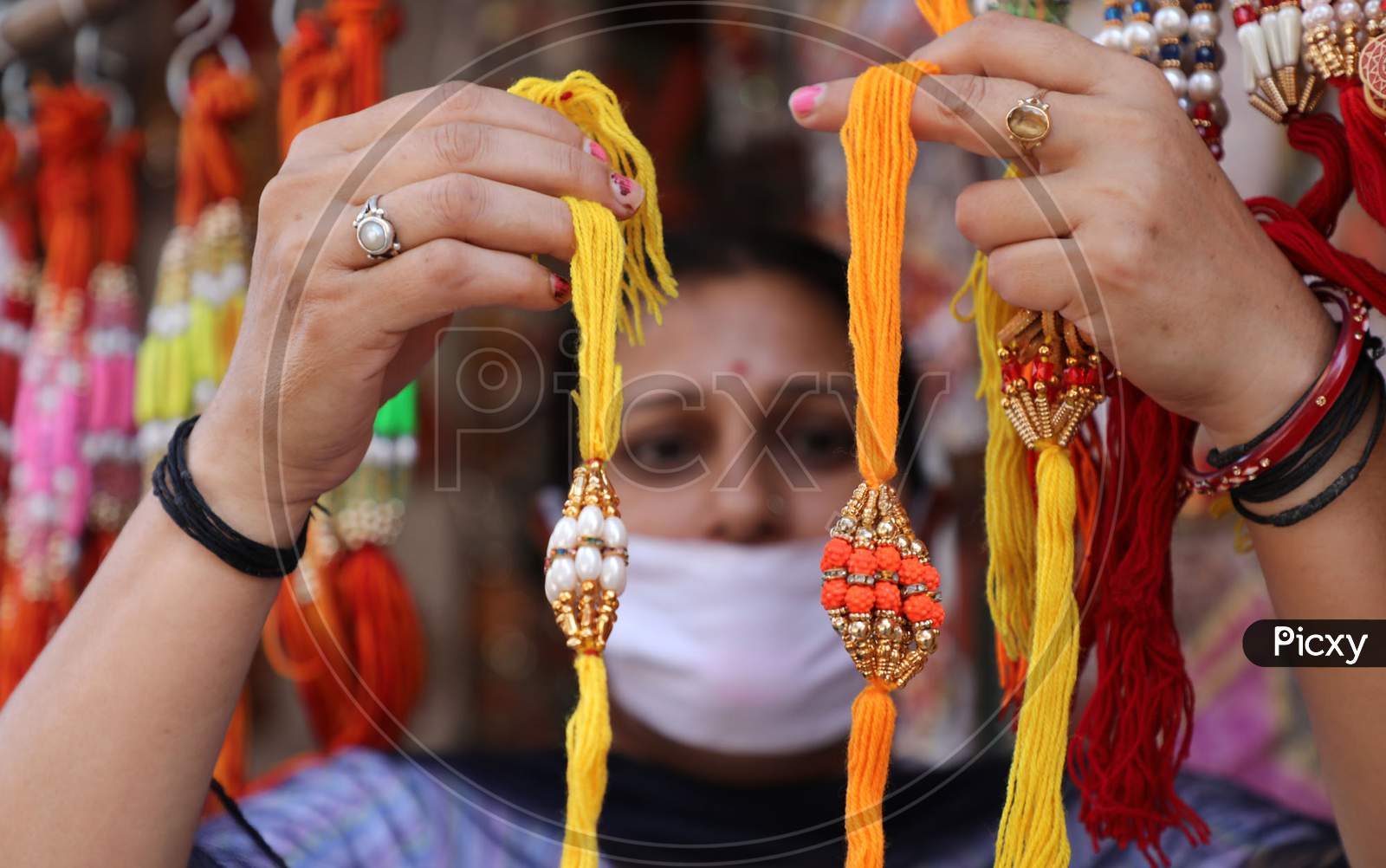 Image of A woman buys rakhi, a bracelet made of thread ahead of ...