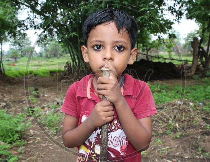 Indian poor farmer boy in field for farming closely shots