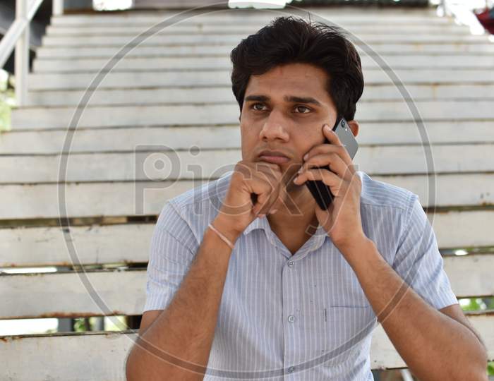indian boy playing mobile phone