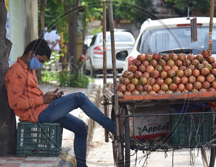 Hyderabad, Telangana, India. July-20-2020: Young Fruits Trader Selling Fruits While Wearing Face Mask, Fruits At Road Side