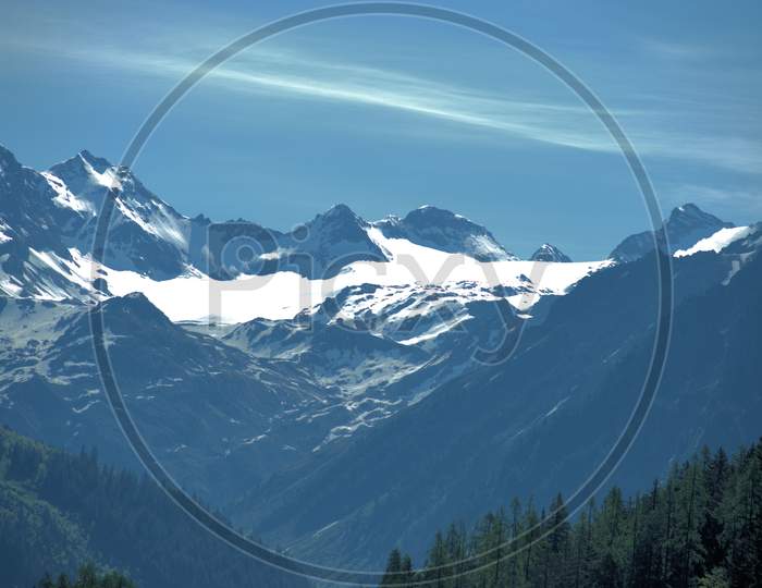 Mountain peaks with snow covered near Klosters in Switzerland 27.5.2020