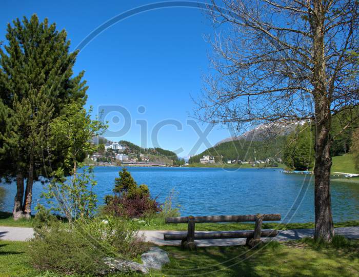 Empty bench a the lake in Saint Moritz Switzerland 27.5.2020