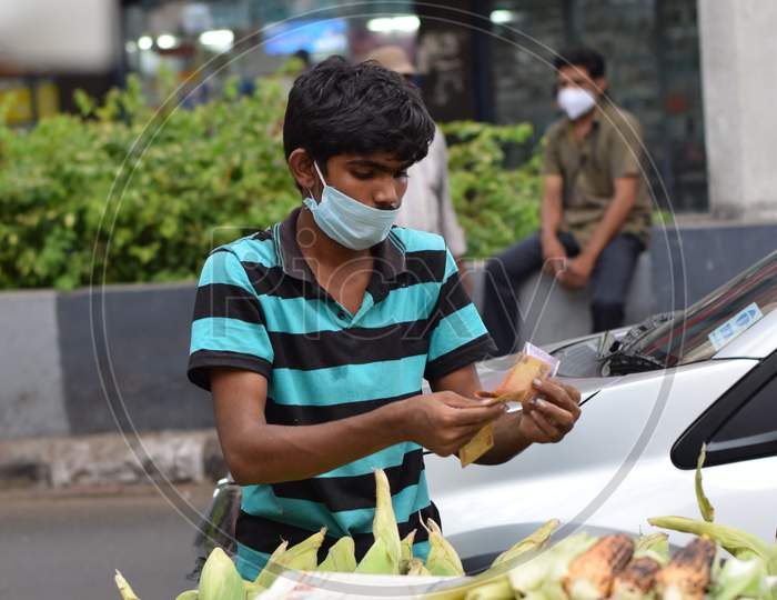 Hyderabad, Telangana, India. July-20-2020: Roasted Corn, People Are Doing Their Work Wearing Face Mask