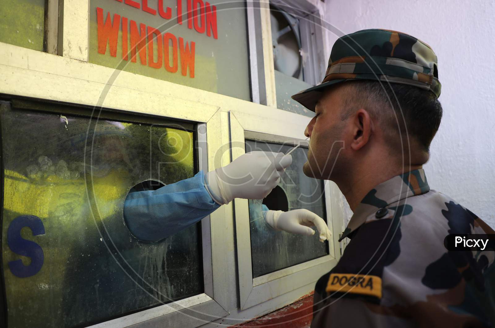 A health worker collects swab samples for Covid-19 testing from a soldier at a Government Hospital in Jammu on July 22, 2020