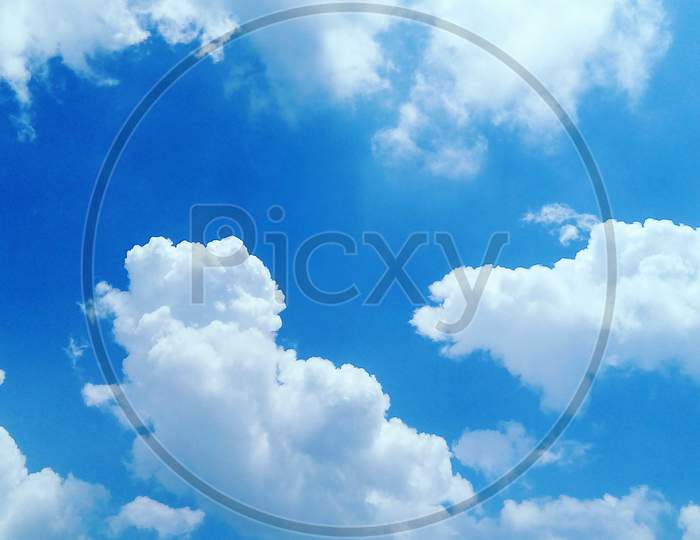 Blue Sky With Fluffy White Clouds