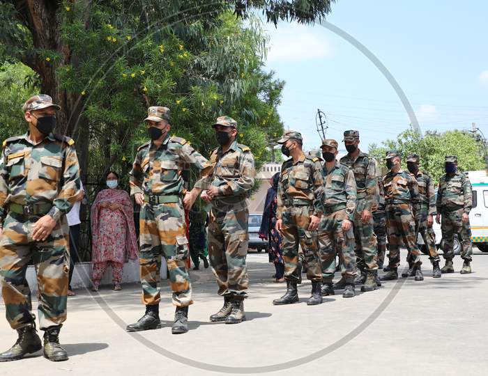 Indian soldiers wait in line to submit swap samples  for Covid-19 testing at a Government Hospital in Jammu on July 22, 2020