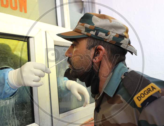 A health worker collects swab samples for Covid-19 testing from a soldier at a Government Hospital in Jammu on July 22, 2020