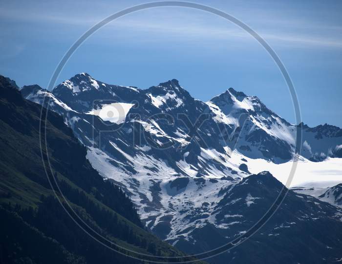 Mountain peaks with snow covered near Klosters in Switzerland 27.5.2020