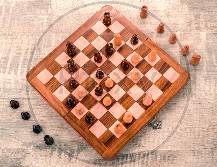 Wooden chess board with pieces top view