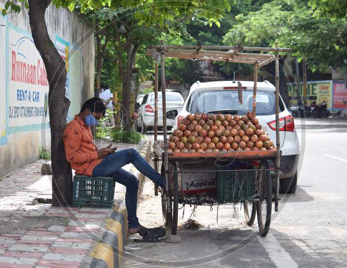 Hyderabad, Telangana, India. July-20-2020: Young Fruits Trader Selling Fruits While Wearing Face Mask, Fruits At Road Side
