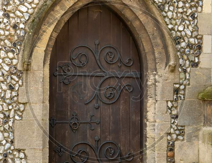 Vintage wooden church door in stone archway