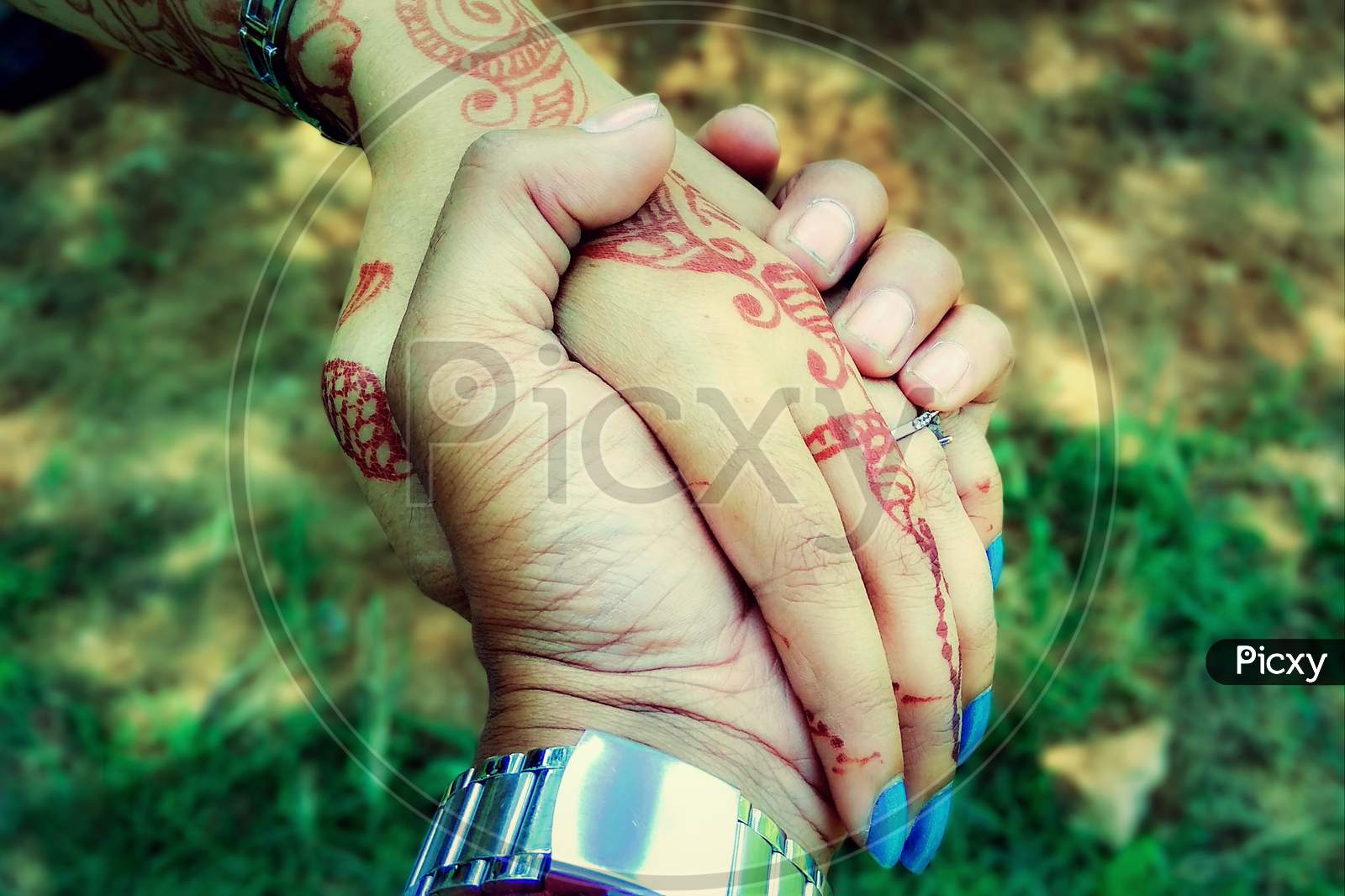 Shot Of Romantic Couple Holding Hands In A Field. Close Up Shot Of Man And Woman With Hand In Hand Walking Through Grass Field
