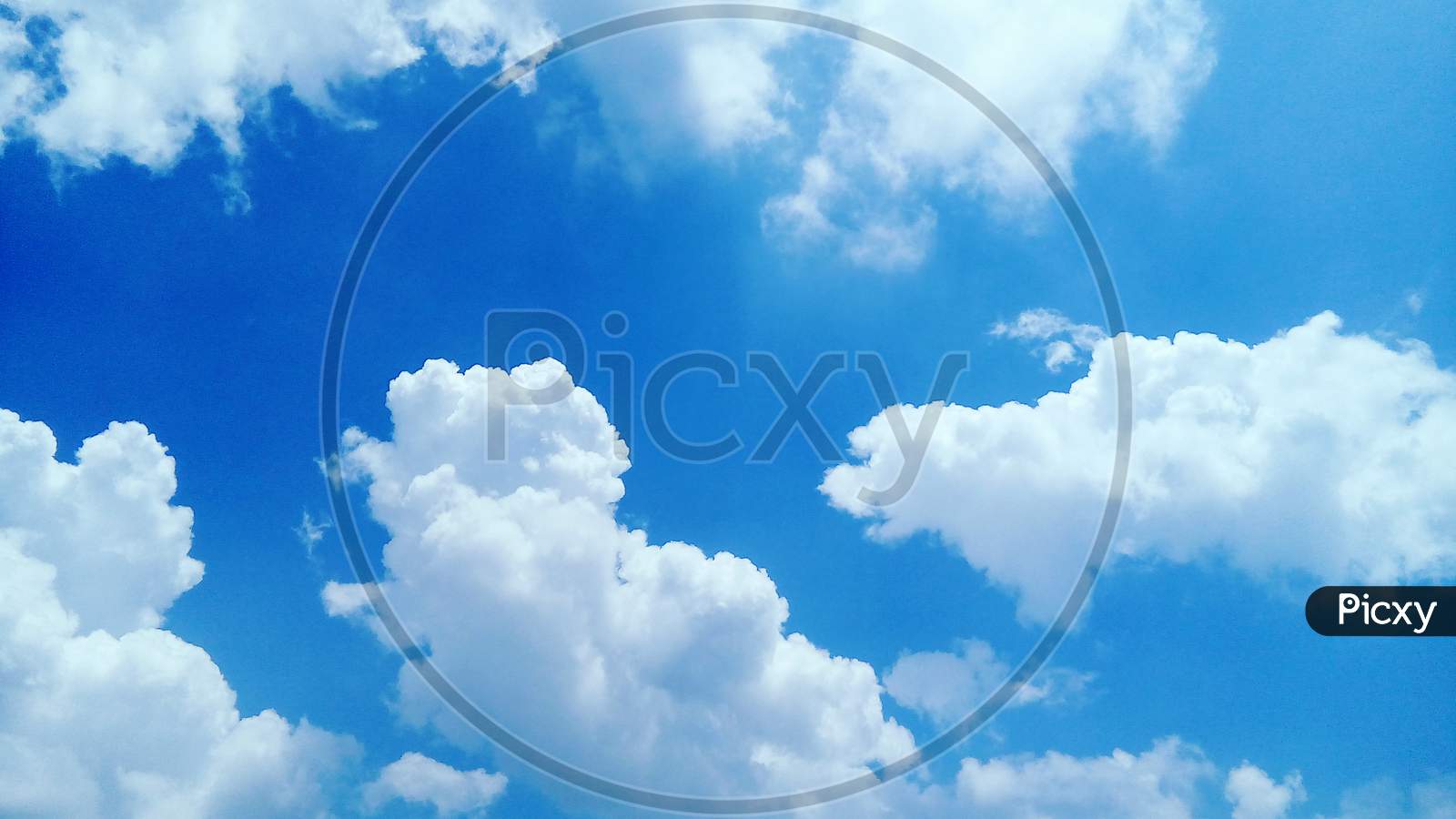 Blue Sky With Fluffy White Clouds