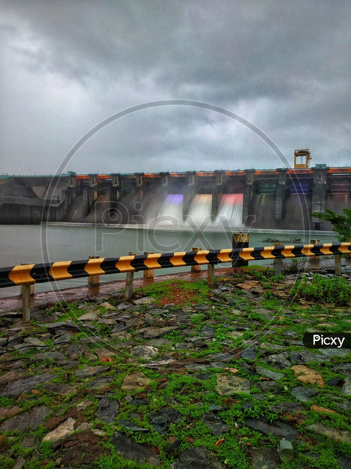 Dam Gates Opened With Colorful Lights On The Water Flowing.