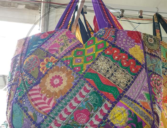 Mandi, Himachal Pradesh / India - 03 07 2020: Photo of a amazing colorful Rajasthani artwork handbag hanging in the shop for sale