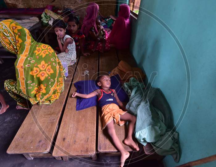A child sleeps inside a flood relief camp at a school in Madhabpara village in Nagaon, Assam on July 22, 2020