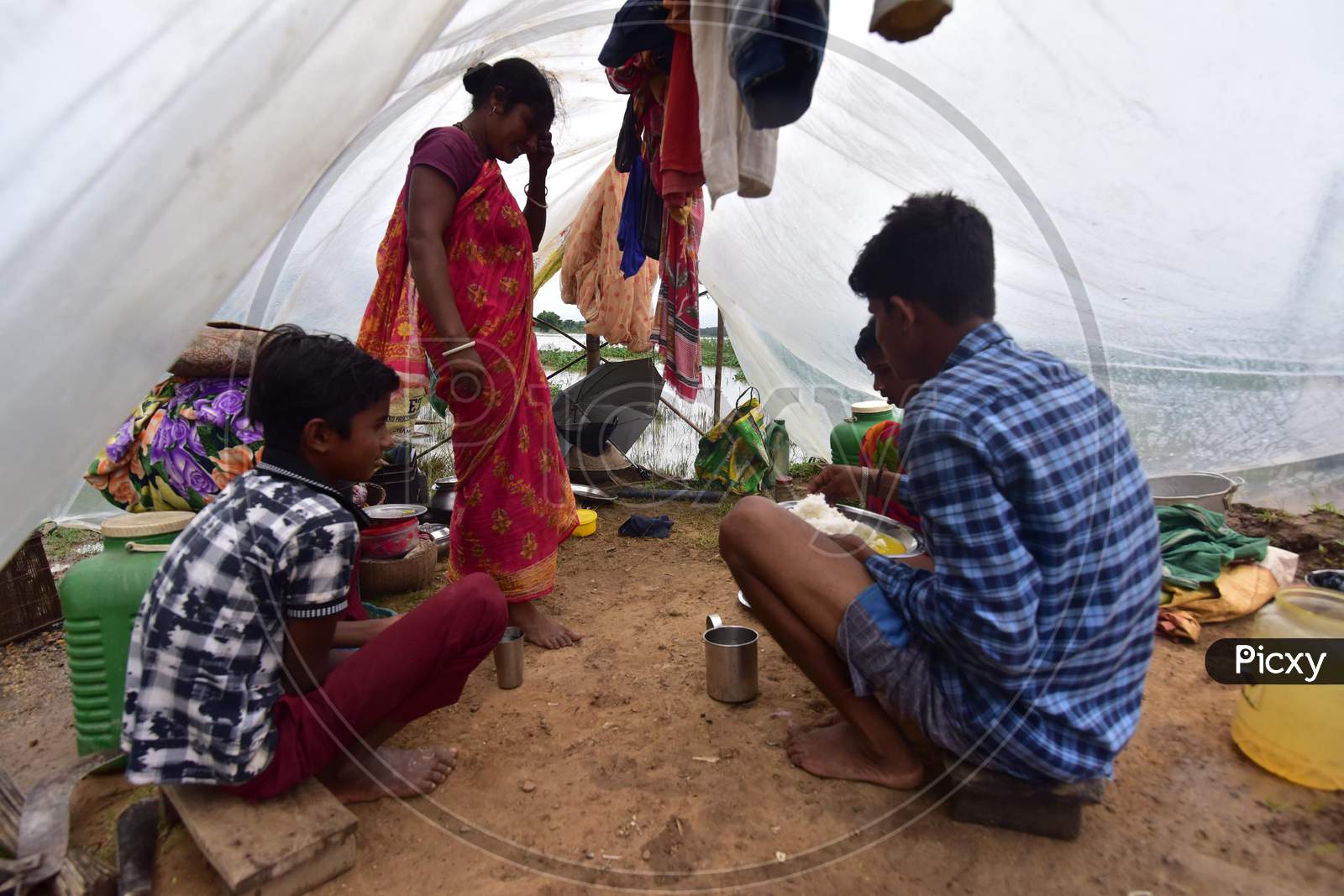 Villagers take shelter in a makeshift camp in a flood-affected village in Nagaon, Assam  on July 22, 2020