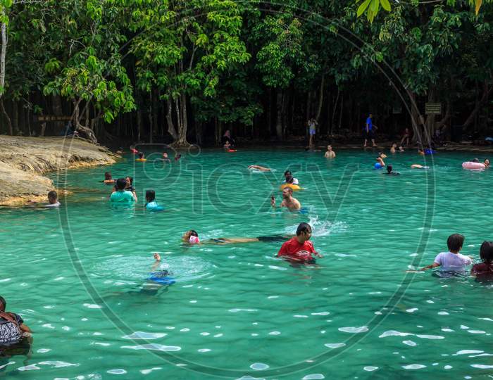 Emerald Crystal Blue Water Pool In Thailand, Citizens And Tourists Swimming