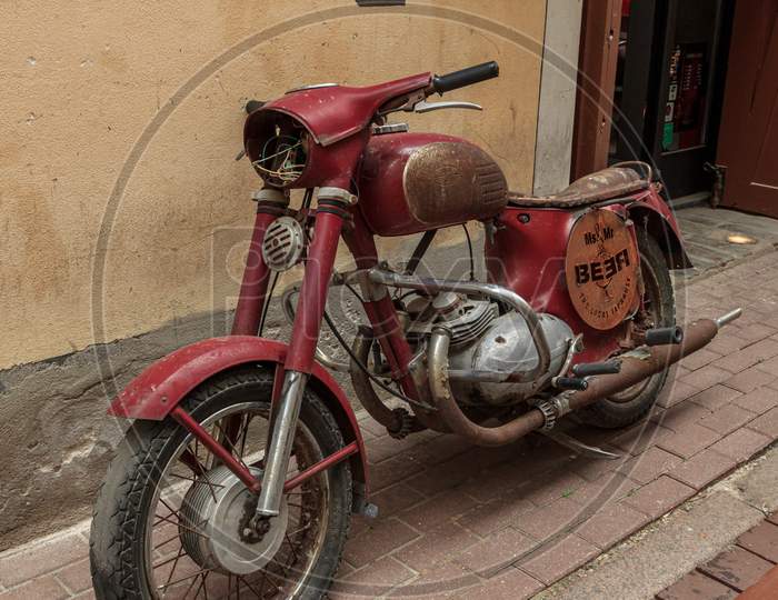 Retro Rusted Red Color Motorcycle Near Bar