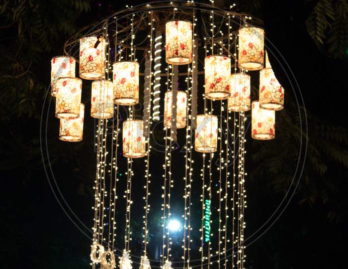 Chandelier light hanging on trees in night