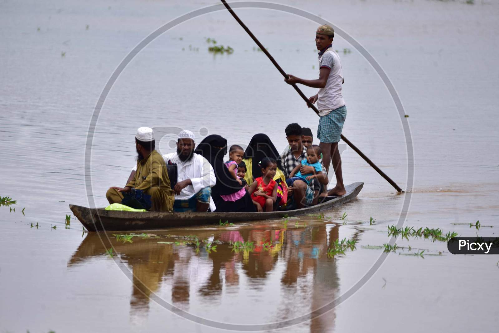 Villagers use a boat to reach a safe place in a flood-affected village in Nagaon, Assam on July 22, 2020