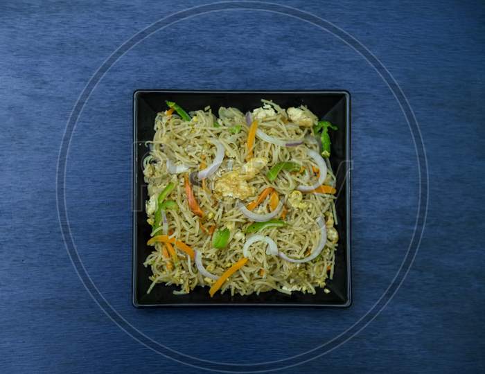 egg chow mein or egg noodles.Delicious Chinese dish is being served with copy space in Indian style.
