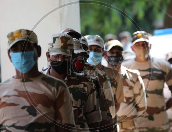 Paramilitary soldiers wait for covid testing outside an isolation ward of Government Medical College, in Jammu on July 23, 2020