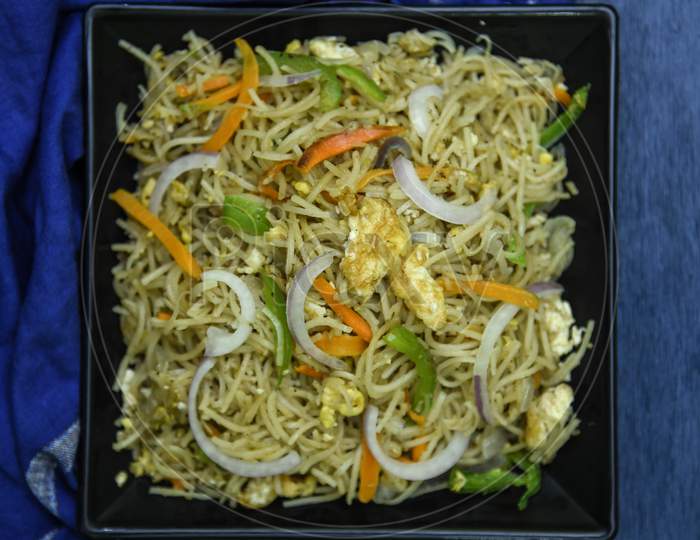 egg chow mein or egg noodles.Delicious Chinese dish is being served with copy space in Indian style.