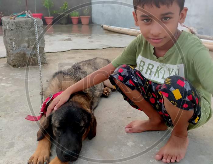 Photography with the pet dog. An Indian child loving his pet dog