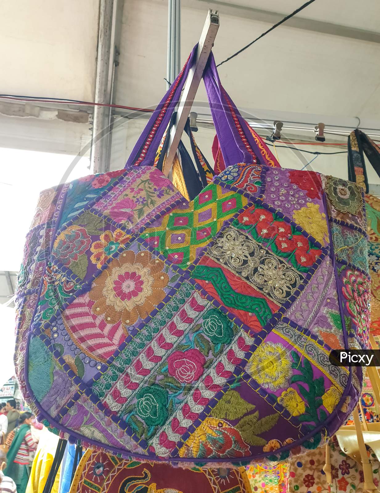 Mandi, Himachal Pradesh / India - 03 07 2020: Photo of a amazing colorful Rajasthani artwork handbag hanging in the shop for sale