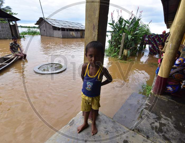 A child takes shelter at a school which has been converted into a flood-relief camp in Madhab Para village in Nagaon, Assam on July 22, 2020
