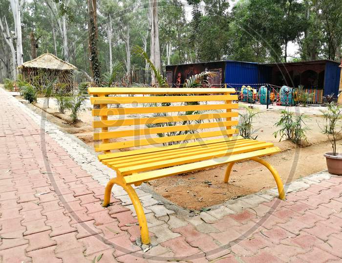 Yellow bench in park for people sitting