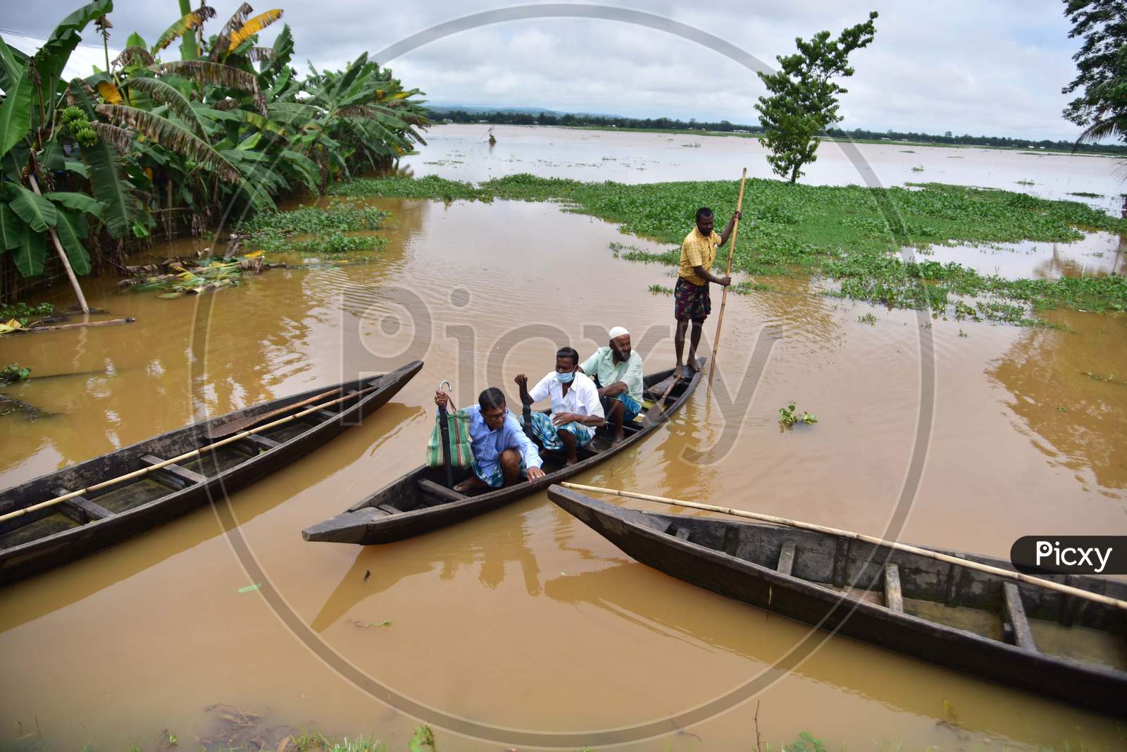 Villagers use a boat to reach to a safer place in a flood-affected village in Nagaon, Assam on July 22, 2020