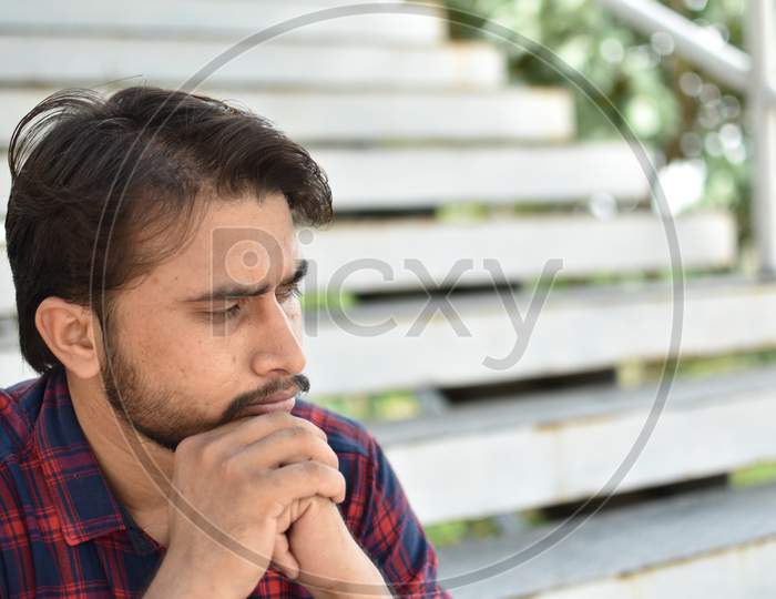 indian college student in deep  thinking position