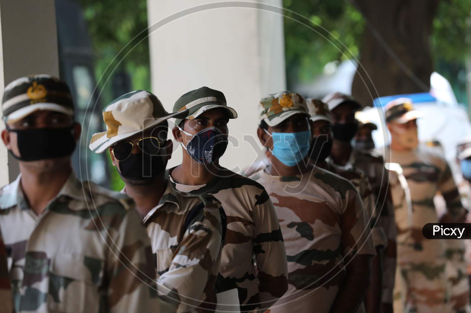 Paramilitary soldiers wait for covid testing outside an isolation ward of Government Medical College, in Jammu on July 23, 2020
