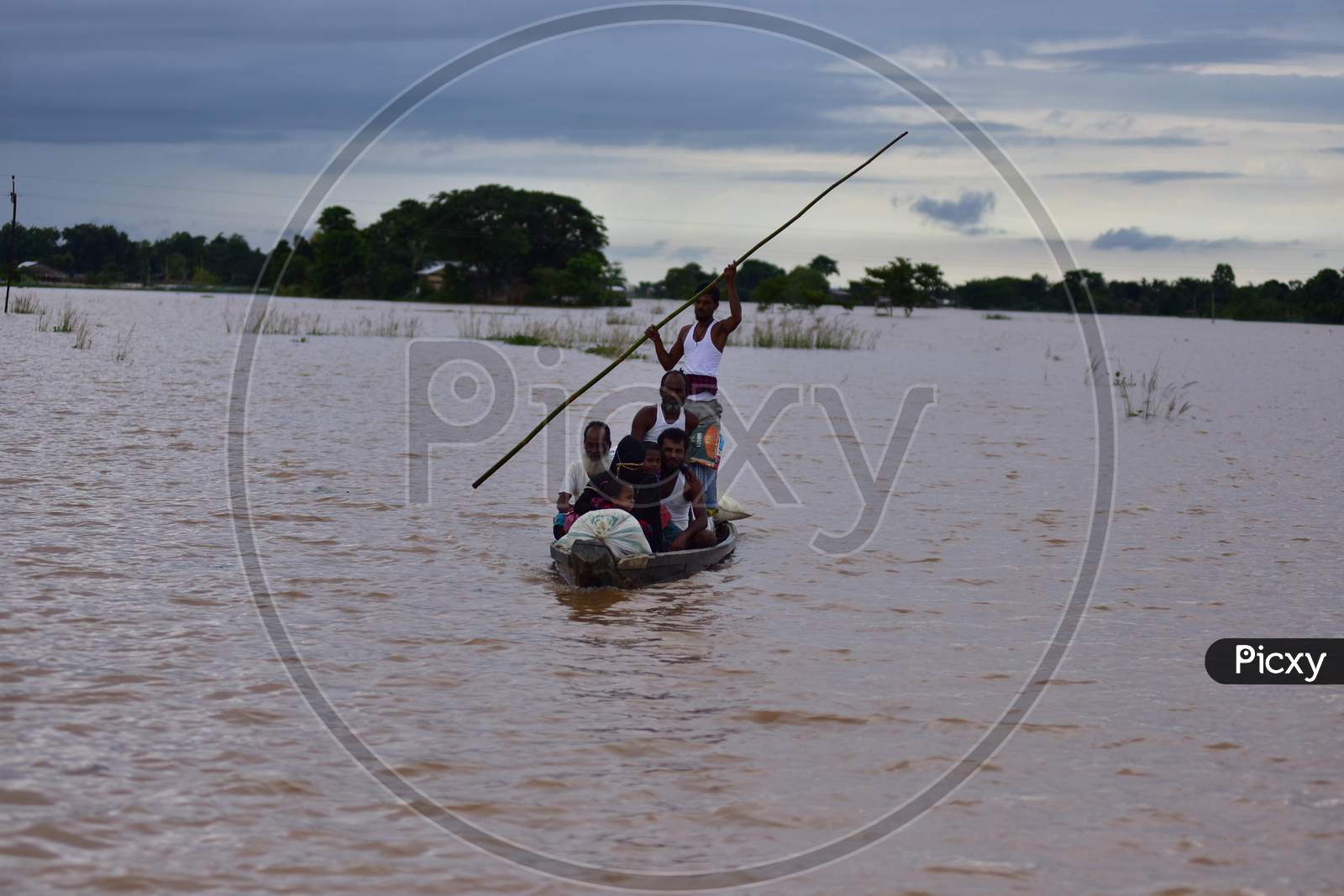 Villagers use a boat to reach a safe place in a flood-affected village in Nagaon, Assam on July 22, 2020