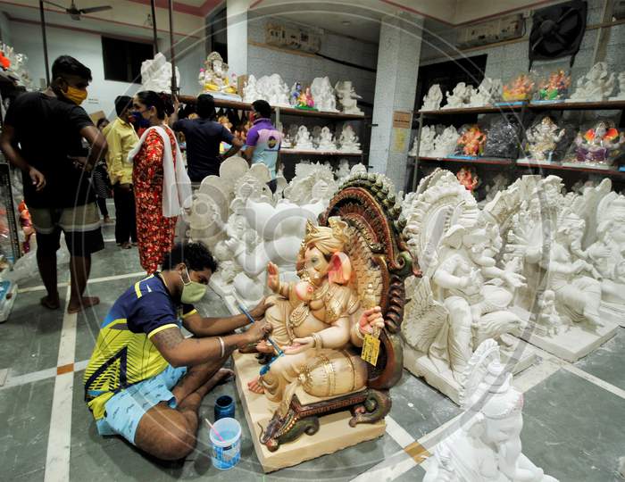 A man works on an idol of Hindu god Ganesh, the deity of prosperity, before the Ganesh Chaturthi festival, at a workshop in Mumbai, India, July 23, 2020.