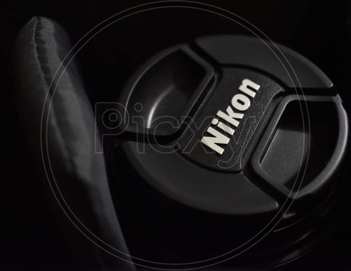 Nikon logo on Nikon camera cap, illustrative editorial image