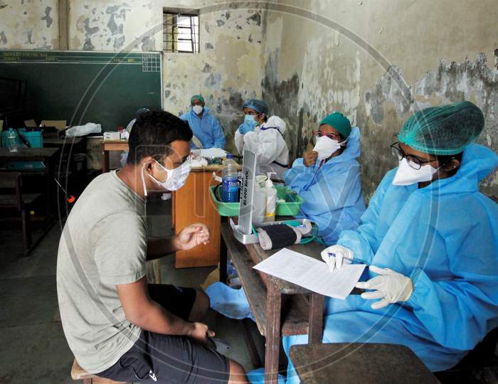 Recovered covid-19 patients give down their details to the healthcare workers during screening for plasma donation,at a camp set inside a classroom of a school, at Dharavi, in Mumbai, India on July 23, 2020.