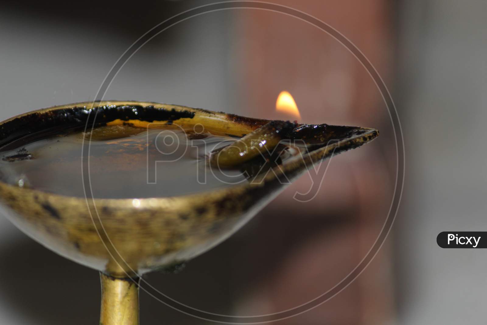 Burning oil lamp and fire with day light background. Closeup.