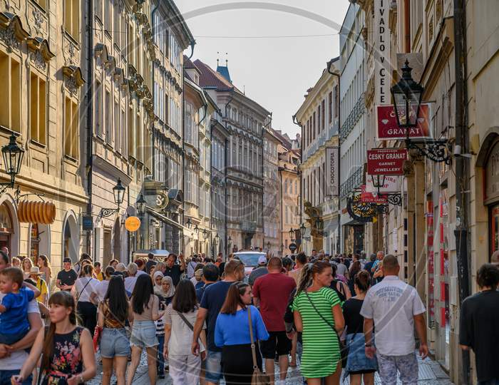 Crowded Tourist Street Scene Between Old Shop Buildings In Prague, Czech Republic