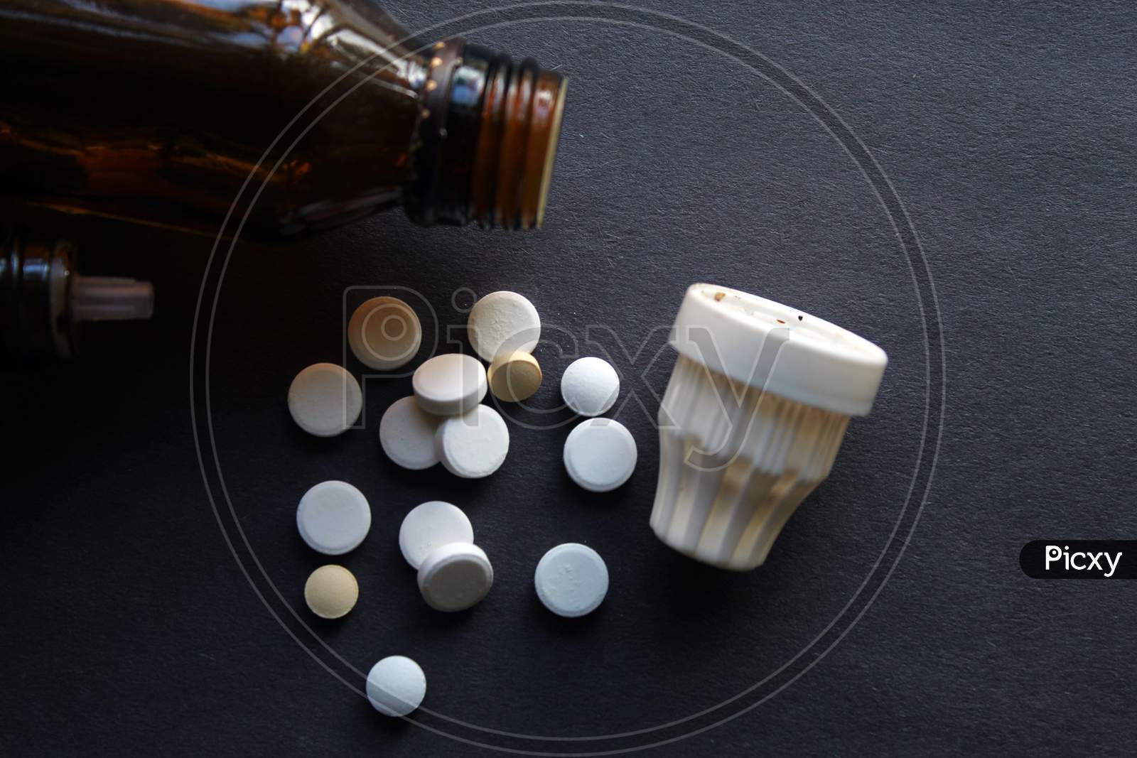 Tablets, pills, medicines and containers display together as medical and pharmacy theme background, selective focus.